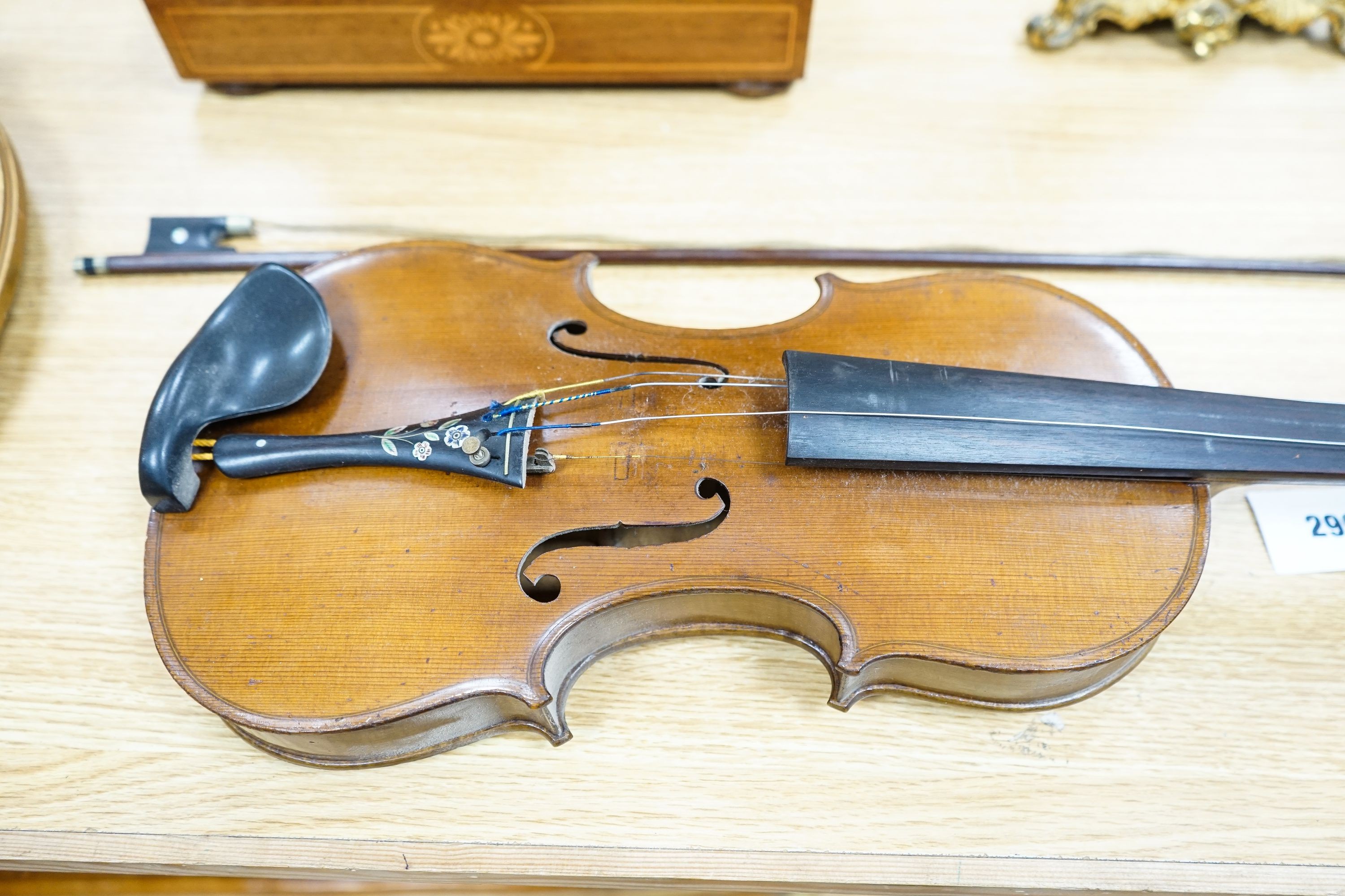 A violin labelled Francesco Ruggeri and a bow. Back of violin excluding button - 36cm